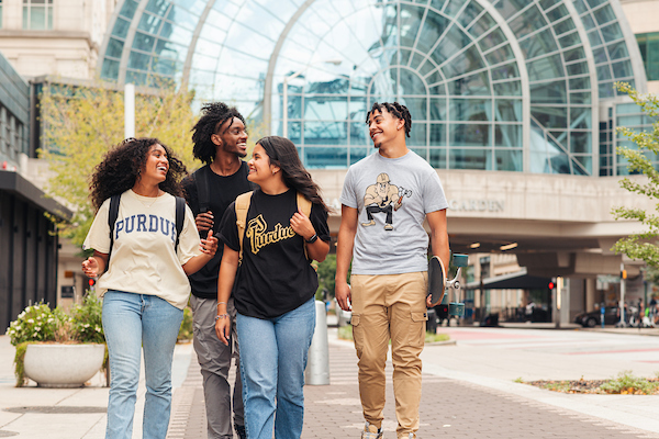 a group of 4 students walking together on the Purdue in Indianapolis campus